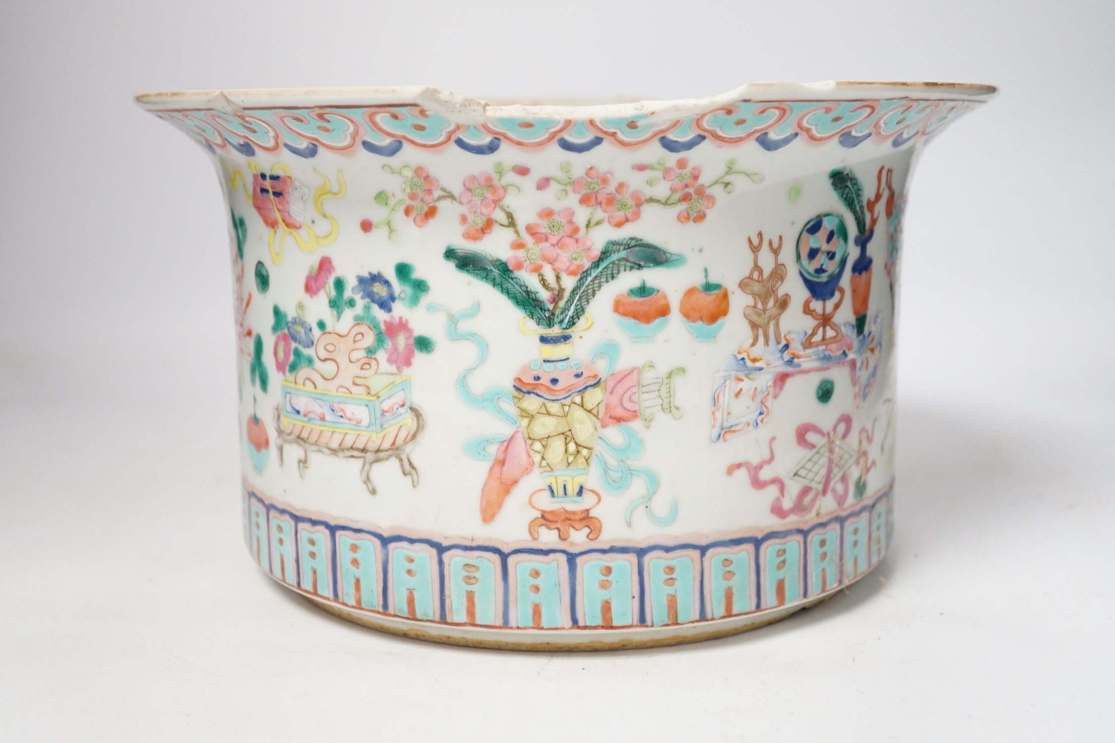 A late 19th century Chinese famille rose planter, decorated with precious objects, 16.5cm high (a/f)